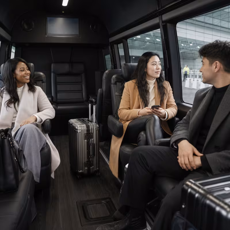 Passengers loading luggage while boarding an Jersey City group shuttle