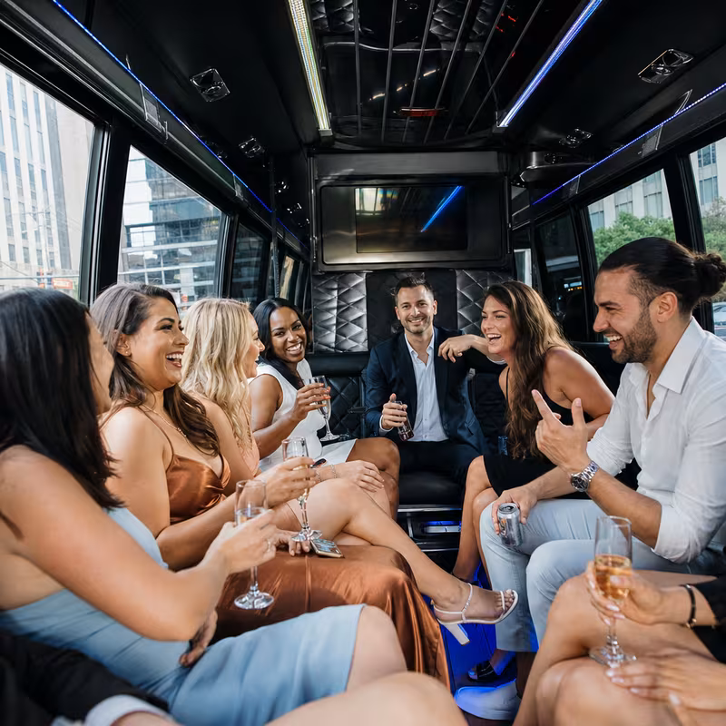 Party bus interior with wraparound leather seating and LED lighting in Jersey City