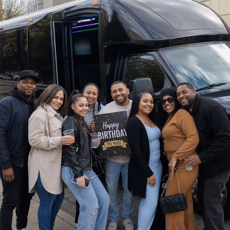 Group boarding a white charter bus for Birthday Transportation transportation in Jersey City