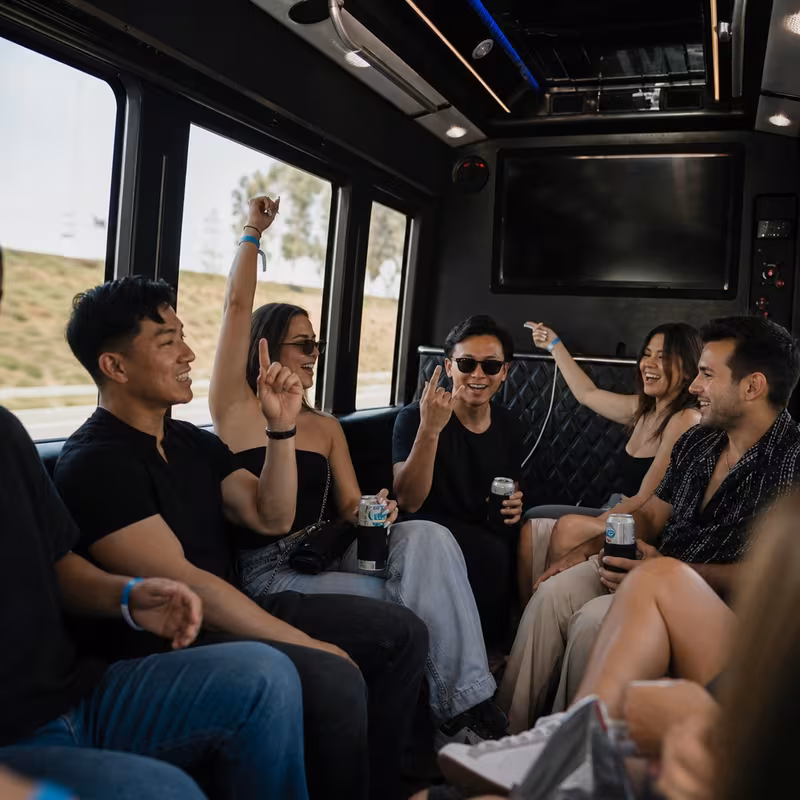 Group boarding a white charter bus for Concert Transportation transportation in Jersey City
