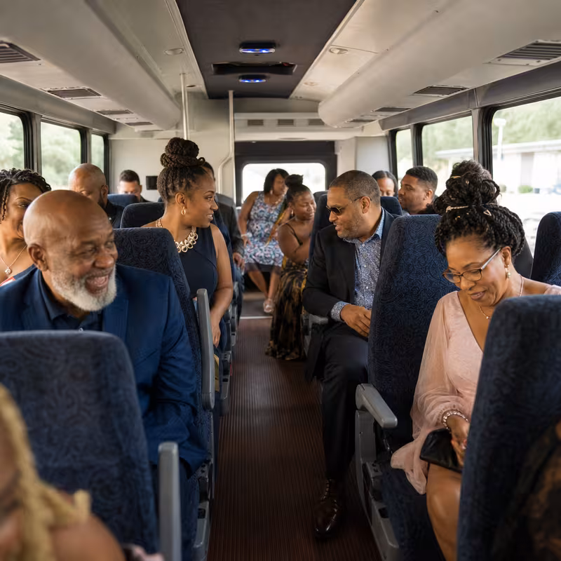 Group boarding a white charter bus for Private Event Transportation transportation in Jersey City