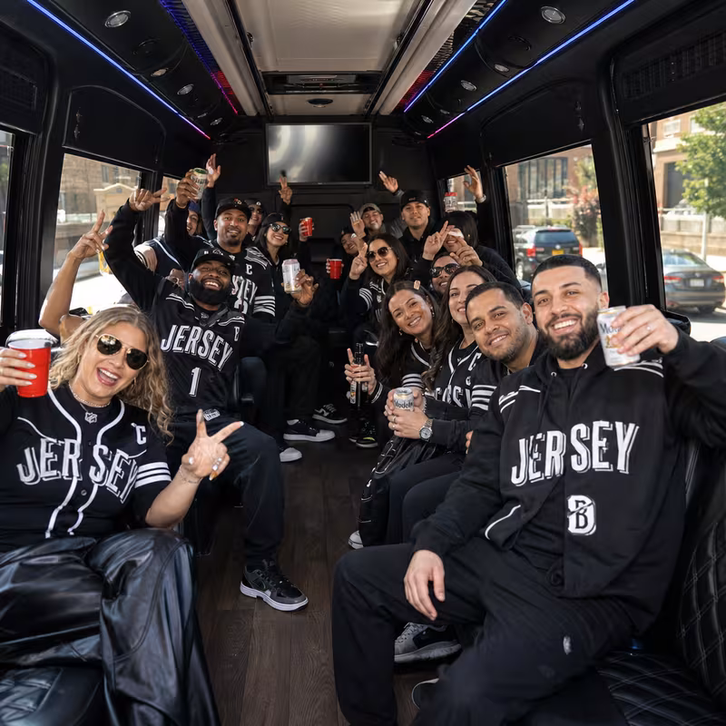 Group boarding a white charter bus for Sporting Event Transportation transportation in Jersey City