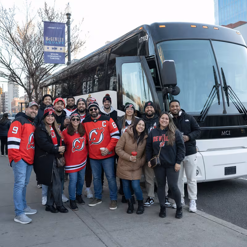 Passengers loading luggage while boarding an Jersey City group shuttle