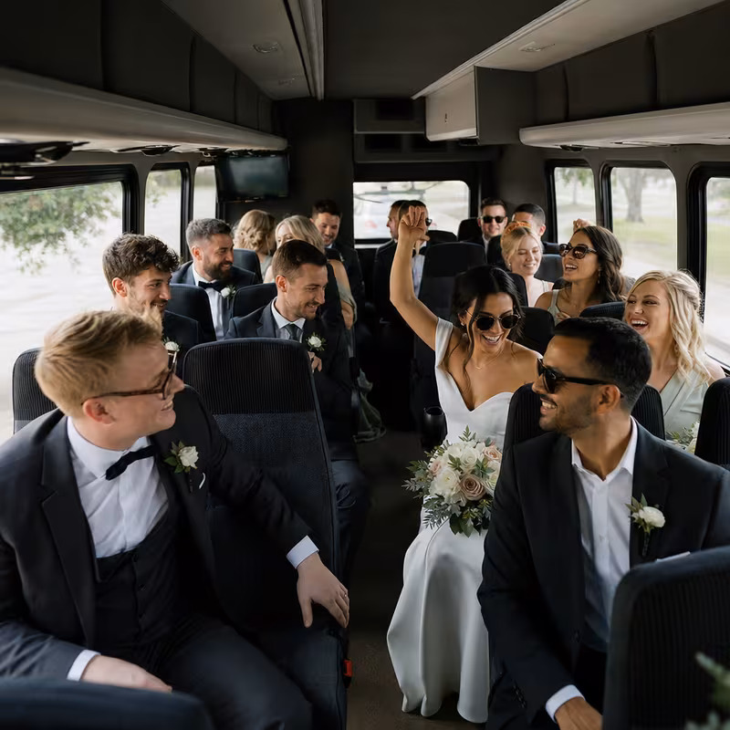 Group boarding a white charter bus for Wedding Transportation transportation in Jersey City