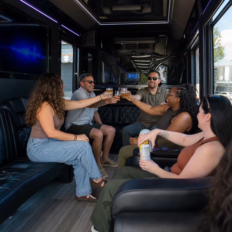 Group boarding a white charter bus for Winery & Brewery Tour Transportation transportation in Jersey City